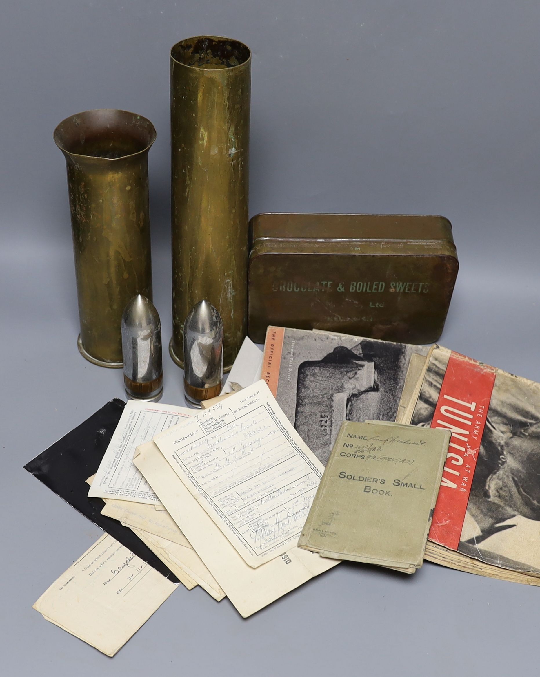 A small group of military ephemera, including documents for 46009 Driver Frank Medhurst 8th Battery R.F.A., shell casings, embroidered badges etc.